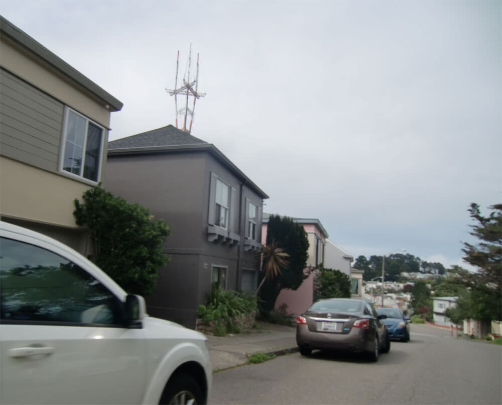 Photo of the Sutro Tower towering over homes