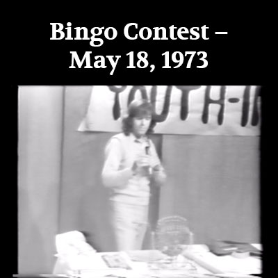 Black and white still of a man reading a bingo ball from the Bingo Contest film. Link to the Bingo Contest film page.